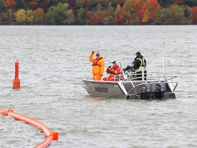 Workers with Enbridge Pipelines deploy inflatable booms during an oil spill response training exercise at Kingston Mills on Thursday. (Elliot Ferguson/The Whig-Standard)