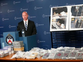 Acting Inspector Steve Watts displays the Toronto Police drug squad's Project Polar, an $8.9M drug seizure of cocaine, meth and ecstacy and also with photos of the sophisticated concealment trap found in a pickup truck, on Thursday October 13, 2016. (Michael Peake/Toronto Sun)