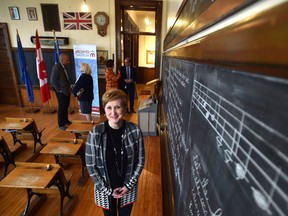 A happy Cindy Davis, Archives and Museum manager at the school, after Randy Boissonnault, MP for Edmonton Centre announced complete $2.4 million roof structural repair and restoration funding for McKay Avenue School in Edmonton Thursday, October 13, 2016. Ed Kaiser/Postmedia