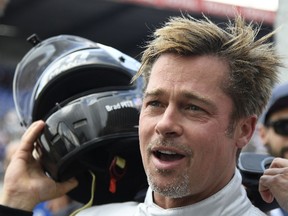 US actor Brad Pitt removes his helmet after a full lap on the Le Mans 24 Hours circuit with a Pescarolo Prototype driven by Austria's Alex Wurz, two-time winner and Grand Marshal for the 84th edition of the Le Mans 24 Hours endurance race, on June 18, 2016 in Le Mans, western France. (JEAN-FRANCOIS MONIER/AFP/Getty Images)
