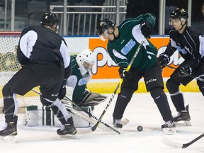 London Knights forward Robert Thomas searches for the loose puck in his skates as goalie Tyler Parsons and defenceman Nicolas Mattinen move to clear it during practice at Budweiser Gardens on Thursday. (CRAIG GLOVER, The London Free Press)
