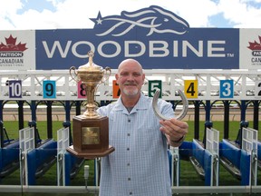 Former Blue Jays pitching great, Duane Ward, poses with the Pattison trophy yesterday at Woodbine. (Michael Burns photo)