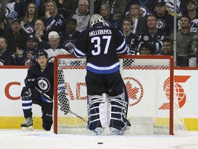 WINNIPEG, MANITOBA - OCTOBER 13: Connor Hellebuyck #37 and Ben Chiarot #7 of the Winnipeg Jets react after the third goal by the Carolina Hurricanes during NHL action on October 22, 2016 at the MTS Centre in Winnipeg, Manitoba. (Photo by Jason Halstead /Getty Images)