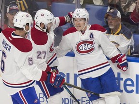 Montreal's Brendan Gallagher celebrates his first period goal with teammates Shea Weber and Alex Galchenyuk as the Canadiens take on the Buffalo Sabres in their season opener at the KeyBank Centre in Buffalo, New York. (AFP PHOTO/Geoff Robins)