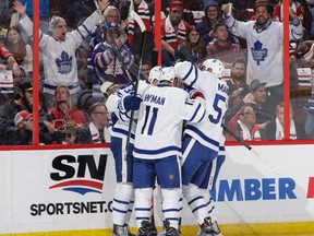 Auston Matthews (34) of the Toronto Maple Leafs celebrates his second career NHL goal against the Ottawa Senators with teammates Zach Hyman (11) and Martin Marincin (52) at Canadian Tire Centre in Ottawa on Oct. 12, 2016, (JANA CHYTILOVA/Getty Images)