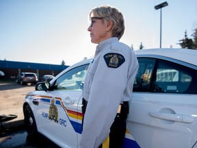 Cpl. Pat Chornoby poses beside an RCMP vehicle at the Stony Plain RCMP Detachment on Oct. 20, 2015. Last October, the RCMP announced its intention to increase enrolment of women to 30 per cent of all members by 2025. - File photo