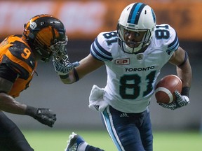Tori Gurley, right, fights off B.C. Lions' Brandon Stewart after making a reception during the second half of a game earlier this year. Gurley is expected to make his Bomber debut on Friday night. (THE CANADIAN PRESS/Darryl Dyck file photo)