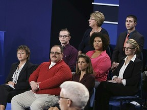 In this file photo dated October 9, 2016 Ken Bone (2nd L) listens to U.S. Democratic nominee Hillary Clinton and Republican nominee Donald Trump during the second presidential debate at Washington University in St. Louis, Missouri. (AFP PHOTO/POOL /Tasos Katopodis)
