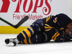 Sabres left winger Evander Kane lies on the ice after crashing into the boards during second period NHL action against the Canadiens in Buffalo, N.Y., on Thursday, Oct. 13, 2016. (Jeffrey T. Barnes/AP Photo)