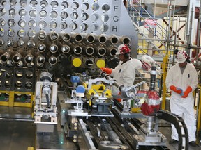 Workers by a a full-scale reactor mock-up,at the Darlington Nuclear Generating Station on Oct. 14, 2016.The first of four reactors will be shutdown at 2 a.m. Saturday morning, marking the beginning of a refurbishment project that is expected to be completed by 2026. (Veronica Henri/Toronto Sun)