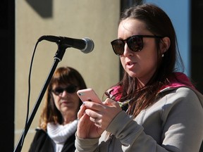 Brooke Metcalfe speaks at city hall in Sarnia during the annual Stand Up Against Poverty rally Friday. Karen Mathewson, with the Porverty Reduction Network of Sarnia-Lambton looks on. About 100 people were in attendance. (Tyler Kula/Sarnia Observer)