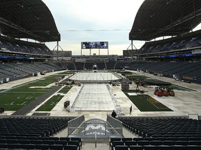 Crews worked Friday at Investors Group Field to ready the stadium for the Heritage Classic. (Kevin King/Winnipeg Sun)