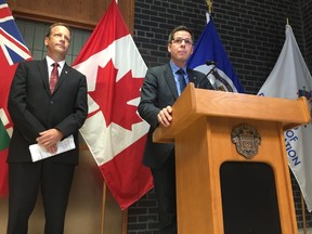 Mayor Brian Bowman (right) speaks as Coun. John Orlikow watches at a press conference on Friday. (DAVID LARKINS/WINNIPEG SUN/POSTMEDIA NETWORK)