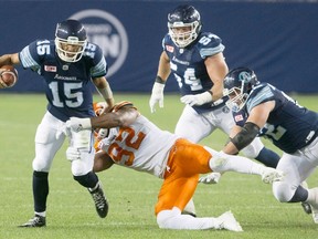 Toronto Argonauts quarterback Ricky Ray (15) is tackled by B.C. Lions' Bryant Turner Jr. earlier this year. (THE CANADIAN PRESS/Chris Young file photo)