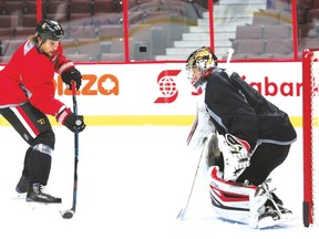 Senators defenceman Erik Karlsson takes a shot on goalie Craig Anderson in practice on Friday. (Jean Levac/Postmedia Network)