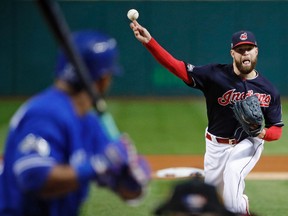 Cleveland Indians starting pitcher Corey Kluber throws to Toronto Blue Jays' Edwin Encarnacion during the first inning in Game 1 of the American League Championship Series in Cleveland on Oct. 14, 2016. (AP Photo/Gene J. Puskar)