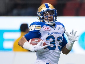 Andrew Harris runs in a touchdown against the Lions on Friday. (CP)