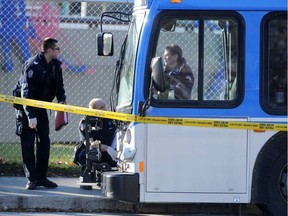 Police investigate the stabbing of a man at around 6:15 a.m. on an ETS Bus at the Coliseum Transit Station in Edmonton on Friday Oct. 17, 2014. Photo by John Lucas