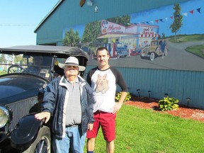 Wayne McMichael, left, and artist Todd Charlton stand next to a 1922 Cardway automobile and a mural unveiled recently on McMichael's barn on Telfer Road on Friday October 14, 2016 in Sarnia, Ont. Paul Morden/Sarnia Observer/Postmedia Network