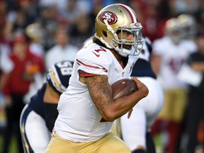 In this Sept. 1, 2016 file photo, file photo, San Francisco 49ers quarterback Colin Kaepernick runs against the San Diego Chargers during the first half of an NFL preseason football game in San Diego. (AP Photo/Denis Poroy, File)