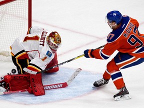 The Edmonton Oilers' Connor McDavid (97) scores a penalty shot goal on the Calgary Flames' goalie Brian Elliott (1) during second period NHL action at Rogers Place, in Edmonton on Wednesday Oct. 12, 2016.