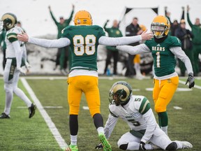 Kicker Brent Arthur and Adam Zajdel of the Alberta Golden Bears, celebrate the winning field goal late in the game against of the University of Regina Rams at Foote Field in Edmonton  on October 15, 2016. The Bears defeated the Rams 19-18 for the first win of the season for the Bears.