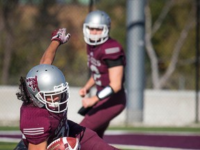 Gee-Gees' Bryce Vieira can't get away from the Western Mustangs' Philippe Dion on Oct. 15. (Ashley Fraser / Postmedia)