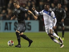 FC Edmonton striker Tomi Ameobi, right, chases Minnesota midfielder Jeb Brovsky in NASL play at the National Sports Center Stadium in Minneapolis, Minn., on Saturday, Oct. 15, 2016