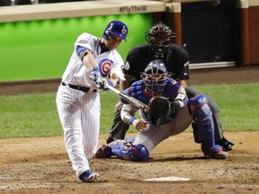 Chicago Cubs' Miguel Montero (47) hits a grand slam during the eighth inning of Game 1 of the National League baseball championship series against the Los Angeles Dodgers Saturday, Oct. 15, 2016, in Chicago. (AP Photo/Charles Rex Arbogast