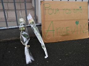 A picture taken on October 16, 2016 in front of a building where a balcony collapsed, shows roses laid and a message reading "for our friends of Angers" in tribute to the four people were killed in the accident. (JEAN-FRANCOIS MONIERJEAN-FRANCOIS MONIER/Getty Images)
