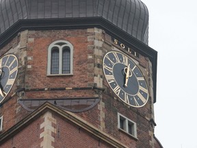 The clocks at St. Katharinen church in Hamburg, Germany, are photographed Sunday Oct. 16, 2016. A 20-kilogram (44-pound) minute hand has fallen off the clock, right, on the Hamburg church tower, plunging 40 meters (some 130 feet) onto the sidewalk below. (Daniel Reinhardt/dpa via AP)