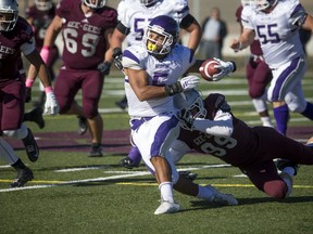The Western Mustangs were in Ottawa to take on the University of Ottawa's Gee-Gee's at the Gee-Gees Field Saturday October 15, 2016. Mustang's Alex Taylor tries to get away from Gee-Gee's Kevin Mackey during Saturday's game. Ashley Fraser / Postmedia  
Ashley Fraser