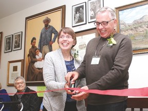 Siblings Jean Hansen Brown and Craig Hansen cut the ribbon signifying the grand opening of phase three of the Vulcan and District Historical Society, Saturday. The siblings cut the ribbon in honour of their father, Henry Hansen, who started the museum many years ago.