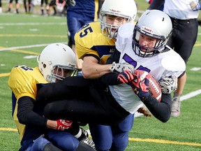 Nathaniel Goupil and James Colburne  of the College Notre Dame Alouettes take down Noah Skuce of the Lo Ellen Knights during senior high school boys football action in Sudbury, Ont. on Friday October 14, 2016. Lo Ellen defeated College Notre Dame.Gino Donato/Sudbury Star/Postmedia Network