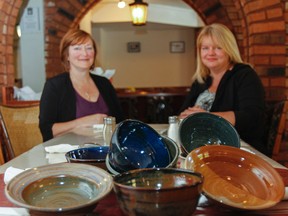 Ronda Candy, left, executive director of Martha's Table, and Tina Malm, administrator, are putting the finishing touches on the Empty Bowls fundraiser, which will take place Oct. 23. (Julia McKay/The Whig-Standard)