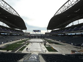 Crews work at Investors Group Field, to ready the stadium for the Heritage Classic, on Fri., Oct. 14, 2016. (Kevin King/Winnipeg Sun/Postmedia Network)