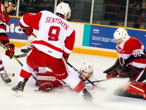 Greyhounds' Boris Katchouk (12) slides into 67's goalie Olivier Lafreniere (right) as Greyhounds' Zach Senyshyn stops in front of the net during OHL action at TD Place Arena in Ottawa on Sunday, Oct. 16, 2016. (Ashley Fraser/Postmedia)