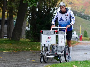 Joe Roberts pushes a shopping cart toward in this file photo. Roberts is pushing the cart across Canada to raise funds and awareness to prevent youth homelessness. Jessica Nyznik/Peterborough Examiner/Postmedia Network file photo