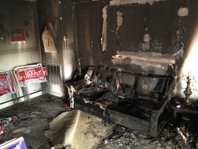 A burnt couch is shown next to warped campaign signs at the Orange County Republican Headquarters in Hillsborough, NC on Sunday, Oct. 16 2016. Someone threw flammable liquid inside a bottle through a window overnight and someone spray-painted an anti-GOP slogan referring to "Nazi Republicans" on a nearby wall, authorities said Sunday. State GOP director Dallas Woodhouse said no one was injured. (AP Photo/Jonathan Drew)