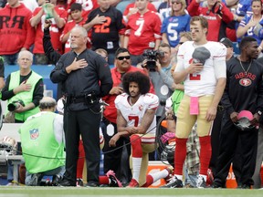 Niners quarterback Colin Kaepernick (7) kneels during the U.S. national anthem before an NFL game against the Bills in Orchard Park, N.Y., on Sunday, Oct. 16, 2016. (Mike Groll/AP Photo)