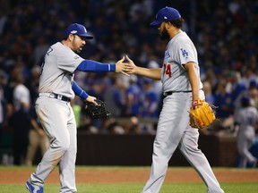 Dodgers first baseman Adrian Gonzalez (23) celebrates with relief pitcher Kenley Jansen (74) after Game 2 of the NLCS against the Cubs in Chicago on Sunday, Oct. 16, 2016. (AP Photo/Nam Y. Huh)