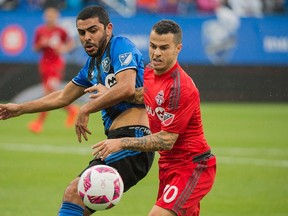 Montreal Impact’s Victor Cabrera, (left) challenges Toronto FC’s Sebastian Giovinco in a 2-2 draw in Montreal yesterday. (The Canadian Press)