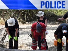 In this Monday, Sept. 26, 2016 file photo, British officers and members of the Greek rescue team search an area of land on the southeastern Greek island of Kos. A British toddler who went missing on a Greek island 25 years ago is believed to have been killed in a construction-site accident that was covered up for almost a quarter of a century, police said Monday, Oct. 17, 2016. (Nikos Panagiotopoulos/InTime News via AP, file)
