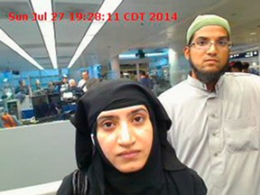 This July 27, 2014, file photo provided by U.S. Customs and Border Protection shows Tashfeen Malik, left, and Syed Farook, as they passed through O'Hare International Airport in Chicago. The husband and wife died on Dec. 2, 2015, in a gun battle with authorities several hours after their assault on a gathering of Farook's colleagues in San Bernardino, Calif.  (U.S. Customs and Border Protection via AP, File)
