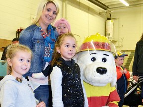 The West Perth Fire Department's open house last Tuesday, Oct. 11, wouldn't have been complete for the Michel family, of Mitchell, without a visit with Sparky. Pictured, from left, are Caley, Kristi, Zoey and Riya Michel. GALEN SIMMONS MITCHELL ADVOCATE