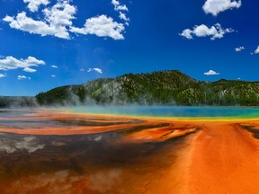 Рanorama of the Grand Prismatic Spring in Yellowstone National Park WY USA. In the background are visible the mountains covered with forests.  (Getty Images)