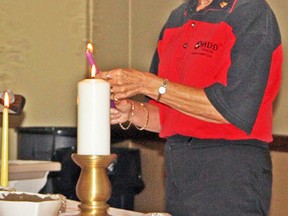 Mary Parkes lights a candle, in this 2011 file photo, at a MADD Sarnia-Lambton candlelight vigil for victims of impaired driving. The annual vigil this year is Oct. 20 at the Point Edward Optimist Hall. (File photo)