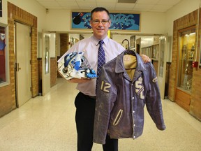 Great Lakes Secondary School principal Paul Wiersma shows off some of the memorabilia now inherited through the recent amalgamation of St. Clair Secondary School and Sarnia Collegiate Institute & Technical School. Candidates are now being sought for a committee to help the school pare down its collection of memorabilia in preparation for its move to the former St. Clair site next school year. (Barbara Simpson/Sarnia Observer/Postmedia Network)