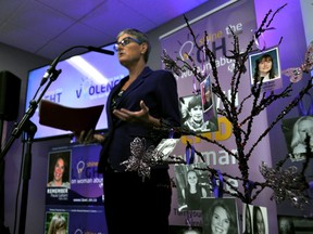 Pictures of the women honoured during the London Abused Women’s Centre’s Shine the Light on Woman Abuse campaigns hang on an ornamental tree while Megan Walker, LAWC’s executive director, launches this year’s campaign in London Ont. October 14, 2016. CHRIS MONTANINI\LONDONER\POSTMEDIA NETWORK