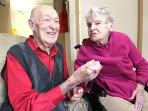 John and Connie Neufeld hold hands in their rooms at the Trillium Retirement and Care Community in Kingston, Ont. on Monday, Oct. 17, 2016. They have just celebrated their 70th wedding anniversary. Michael Lea The Whig-Standard
